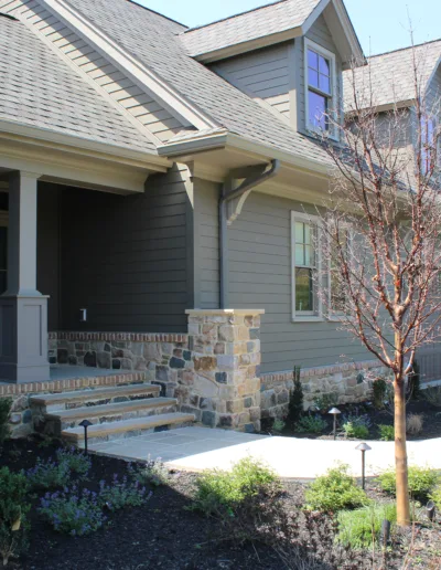 The front of a house with a driveway and landscaping.